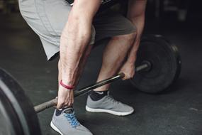 man lifting a barbell