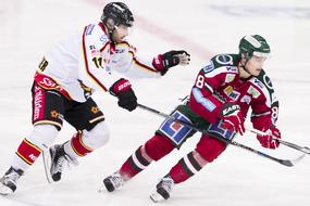 Jacob Micflikier and Andrew Johnson in colorful uniform, playing hockey on the competition