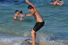 man riding a surfboard at the sea