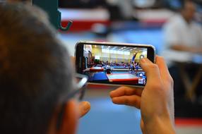 sports on smartphone screen in blurred background