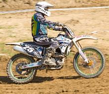 motorcycle racer in the dust on a sunny day