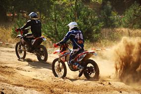 motorcycle riders in the dust on a sunny day