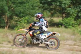 motorcyclist on the track near the trees