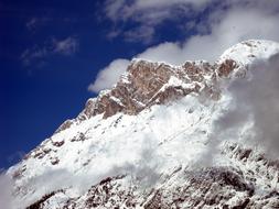 clouds over snowy mountain range