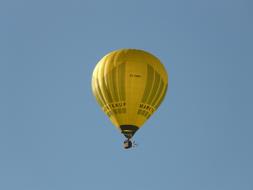 yellow hot air balloon in blue sky