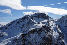 Beautiful, snowy mountains in sunlight, in SÃ¶lden, Austria, under the blue sky with white clouds