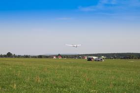 Glider flying above the colorful and beautiful field with grass in Swietokrzyskie, Poland