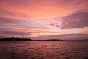lake with calm water during sunset