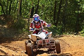 Motocross, rider on quad in front of forest