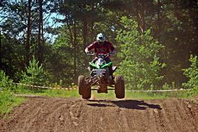 Enduro Motocross, rider on Quad jumps over road