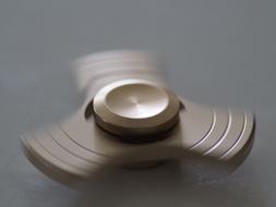 rotating toy on gray background