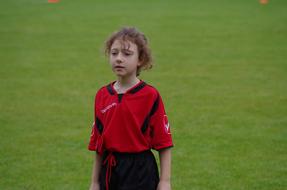 Cricketer girl player on the green grass field