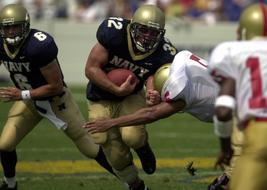 players fighting for the ball while playing American football