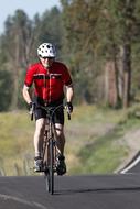 cyclist rides on an asphalt road