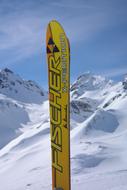 advertising on a yellow ski in the snowy mountains