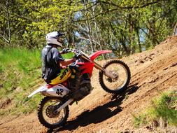 motorcycle racer drives up a hill