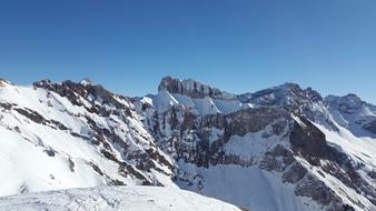 alpine mountains in the snow in winter under the blue sky