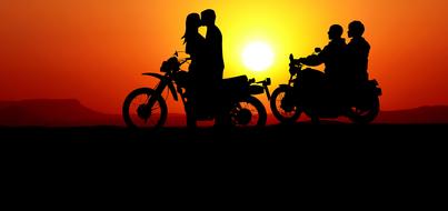 silhouettes of loving couples on motorcycles at sunset