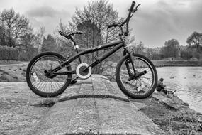 Black and white photo of the bike near the water