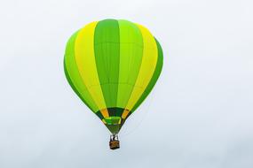 yellow green hot air balloon at cloudy sky