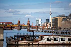 barge against the background of a bridge and a television tower in Berlin