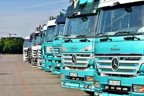 commercial trucks in a row on a sunny day