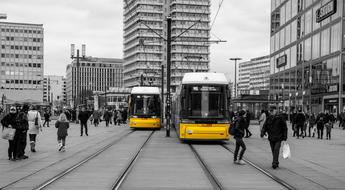 yellow trams on the streets of berlin in monochrome