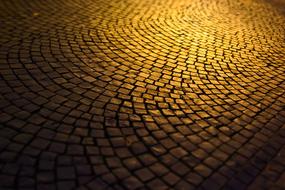 paving stones in the square under the light of a street lamp