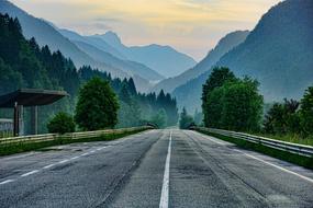 evening photo of highway on a background of foggy mountains