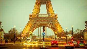 photo of car traffic under the Eiffel Tower