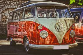 shiny red white vw camping bus on display