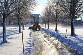 Machine on the beautiful road, among the trees, in sunlight and snow, on the landscape