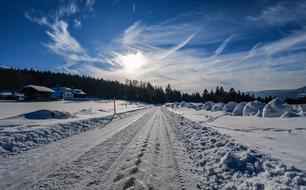 evening photo of a snowy road in NeuchÃ¢tel, Switzerland