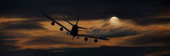 flying airplane on the background of the moon