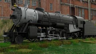 Beautiful, black and grey steam locomotive among the brick building and green grass