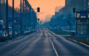 Vehicles on the of the Karl Marx Allee, in Berlin, Germany, at orange sunset