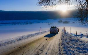 cars on a snowy road in the countryside in switzerland