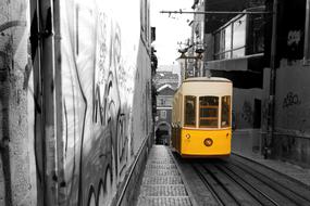 yellow tram on the streets of the old town in lisbon