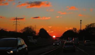 Traffic on wide road at Sunset