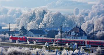 photo of a red train at a train station in Germany