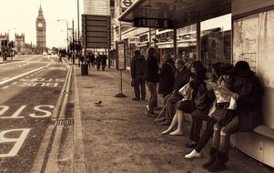 people waiting transport on stop in city, uk, england, london