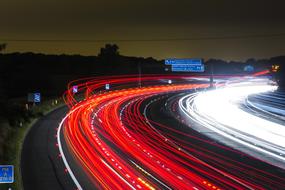 Colorful lights of the traffic on the road, in motion, in the evening