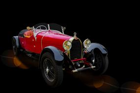 Beautiful red retro car on the dark background