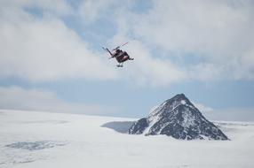 helicopter over antarctica on a sunny day