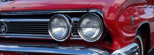 round headlights of a red retro 1950 car