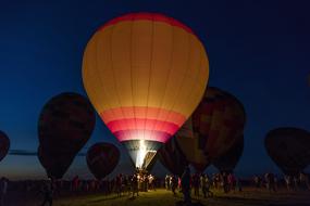 people near Hot Air Balloons at Night