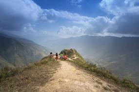 People on the beautiful mountain in Ha Giang, Vietnam, with the green plants, under the blue sky with clouds