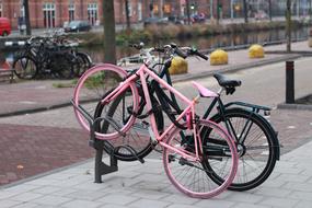 parked pink and black bikes