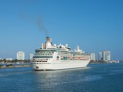 Cruise Ship on water near coastal city