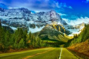 Panorama of road and snowy mountains in Banff National Park, Canada